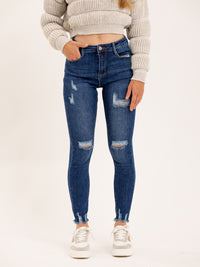 Jean skinny bleu genoux destroy ourlet brut