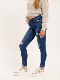 Jean skinny bleu genoux destroy ourlet brut